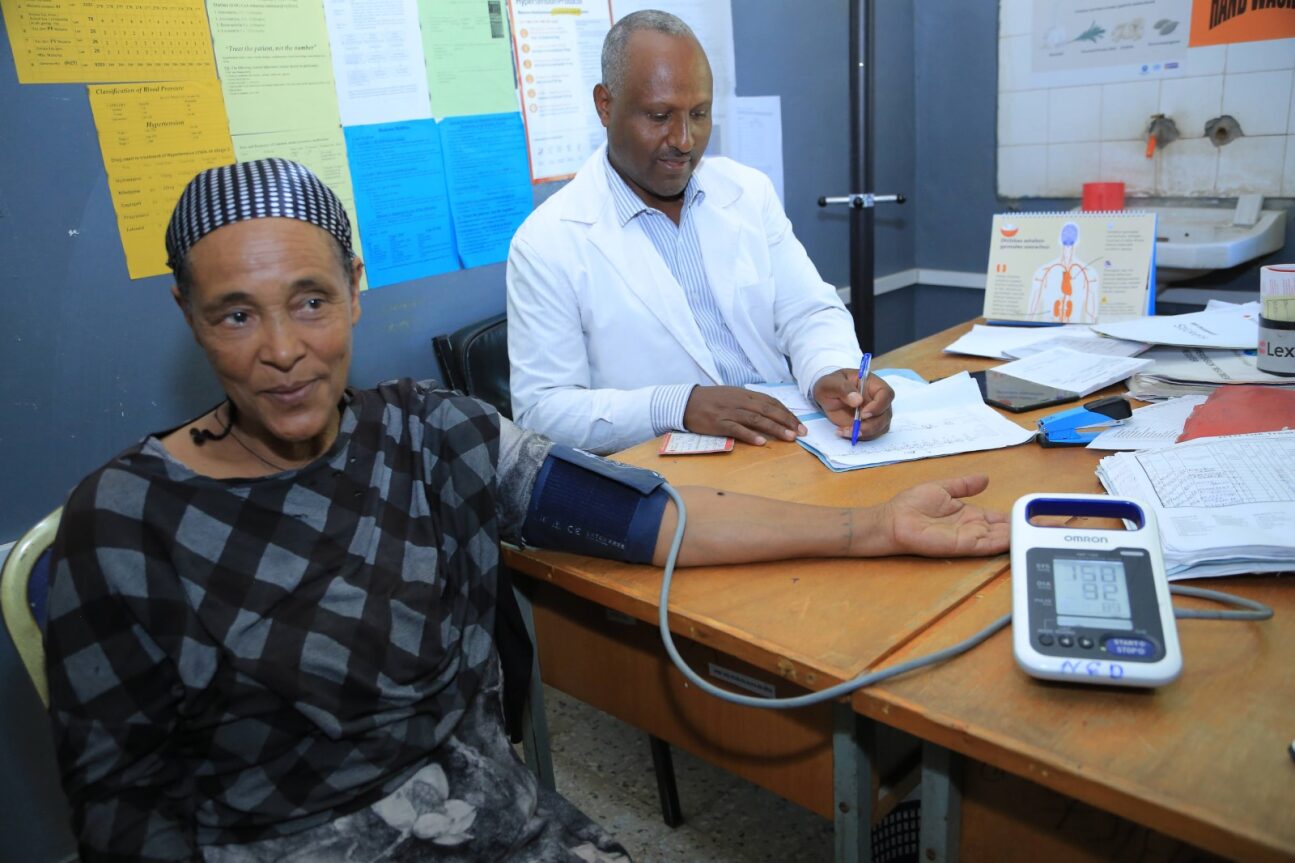 A woman in Ethiopia has her blood pressure taken by a doctor