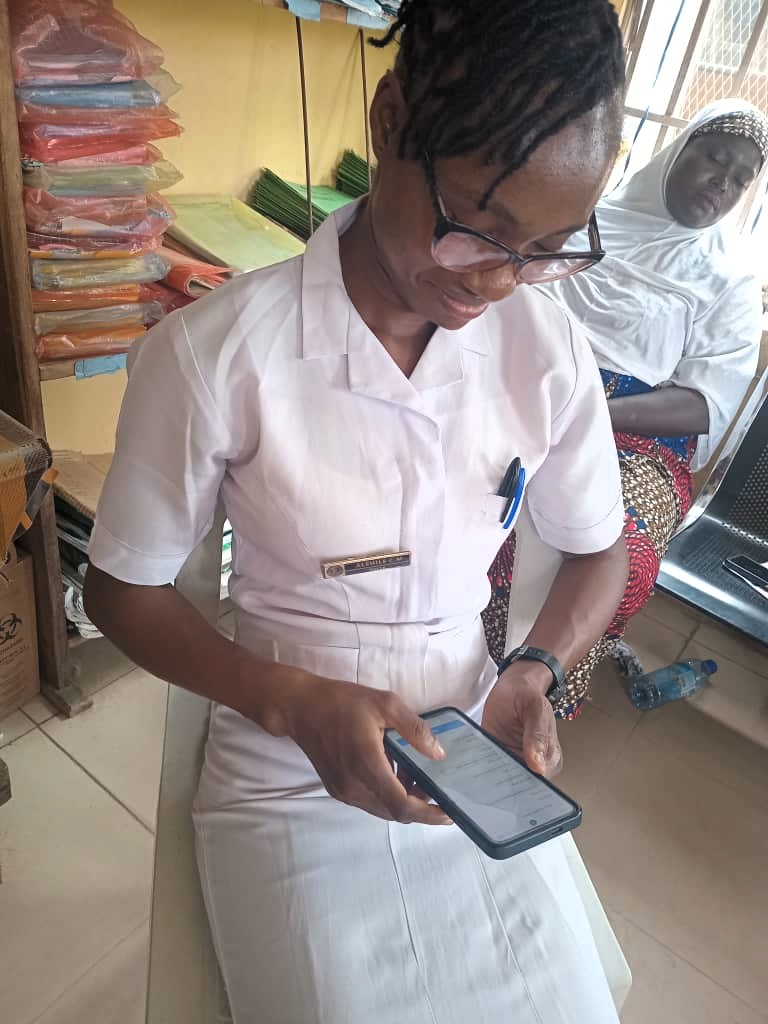 A health care worker in Nigeria completes the cIDSR course on her smartphone. Credit: Resolve to Save Lives.