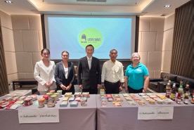 members of Thai Low Salt standing behind table with low sodium food products