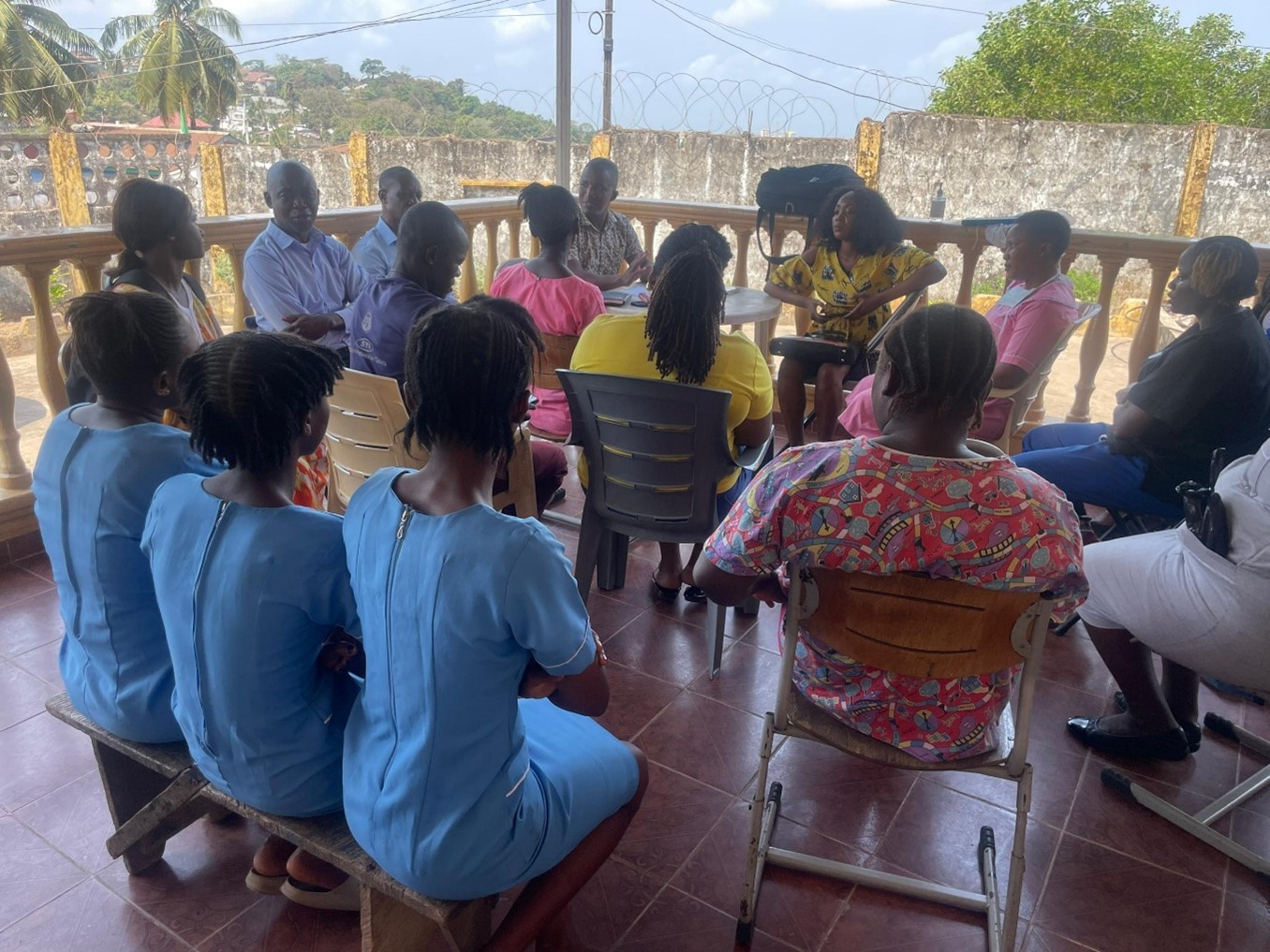 A debrief session with health care workers following a patient simulation exercise.