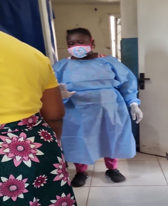 A health care worker attends to a simulated patient.