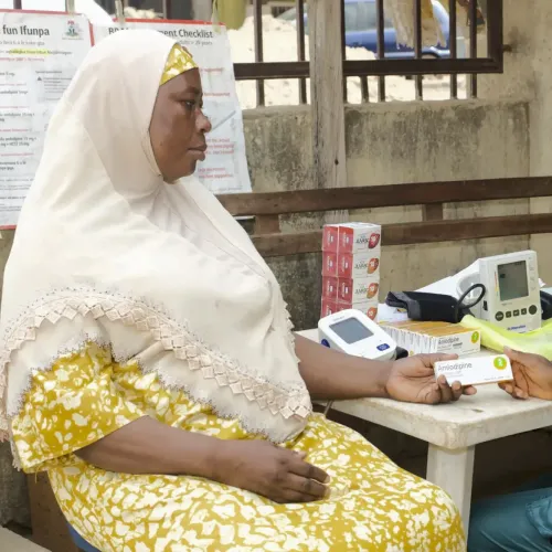 A Nigerian woman having her blood pressure taken